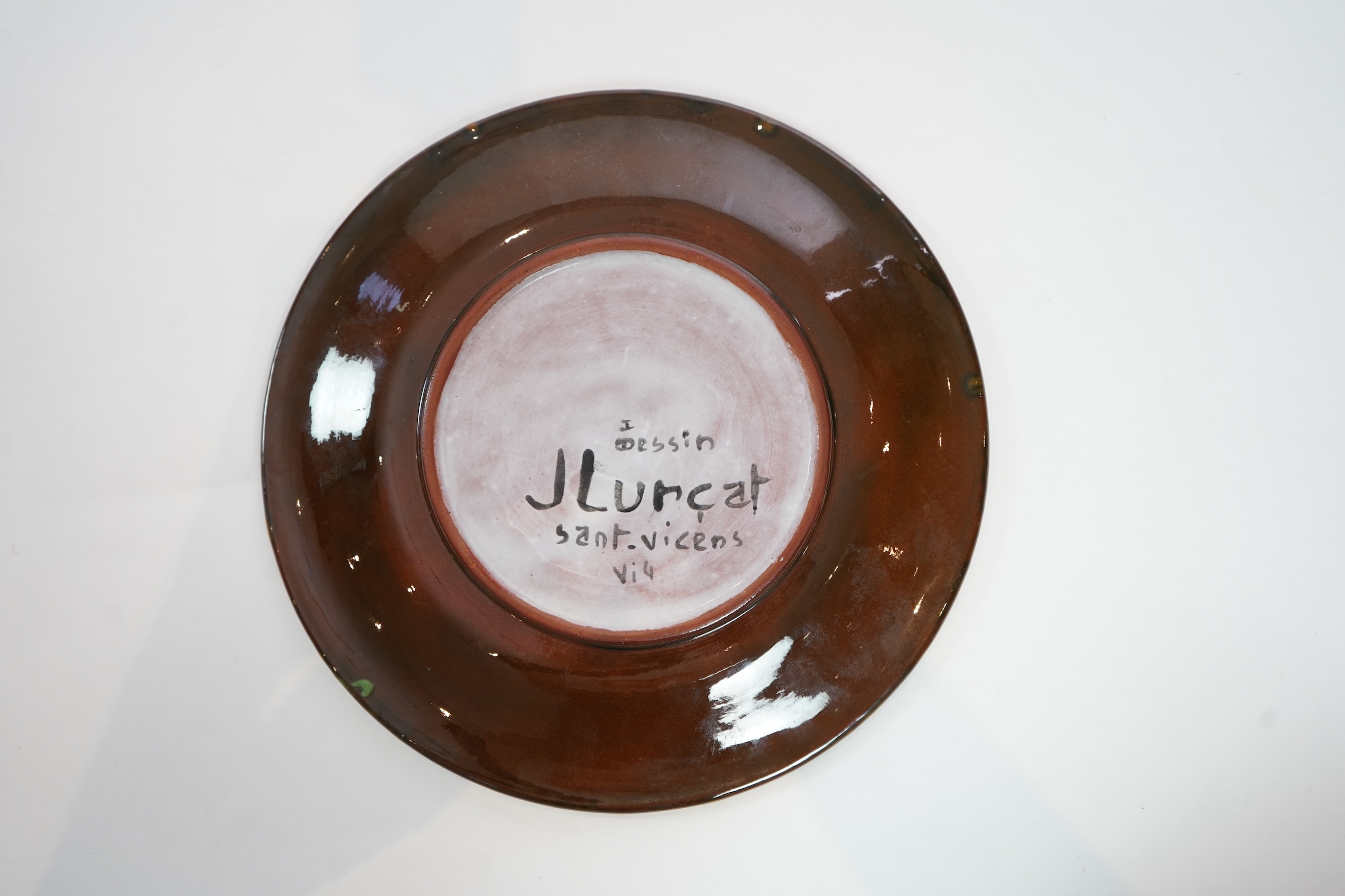 Jean Lurçat (1892-1966): A green glazed earthenware plate, decorated with a stylised central figure